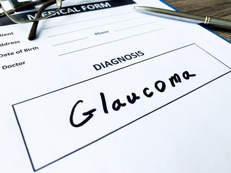 Diagnosis glaucoma in a medical form on the doctor desk.の写真素材
