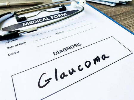 Diagnosis glaucoma in a medical form on the doctor desk.の写真素材