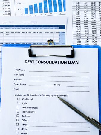 Debt consolidation loan document with graph on table.の写真素材