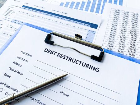 Debt restructuring document with graph on table.の写真素材