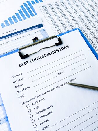 Debt consolidation loan document with graph on table.の写真素材