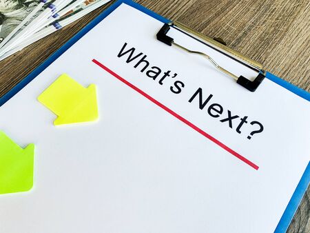 Clipboard with text whats next on wood desk.の写真素材