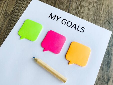 Clipboard with my goals on wood desk.の写真素材