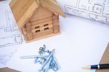 Building new home. Close up of house blueprint with building toolsの写真素材