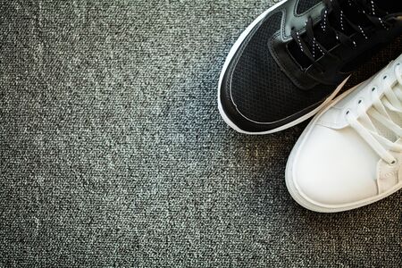 Pair of new stylish sneakers on floor at home.の写真素材