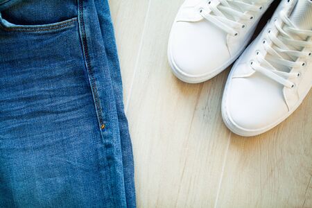Pair of new stylish white sneakers on wood floor.の写真素材