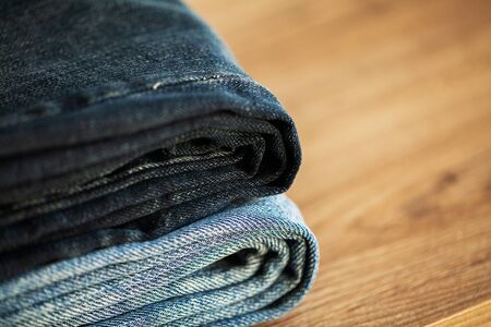 Denim blue jeans stack texture background closeup.の写真素材