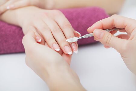 Woman hands in a nail salon receiving a manicure procedure. SPA manicure.の写真素材