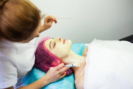Spa therapy for young woman having facial mask at beauty salon.の写真素材