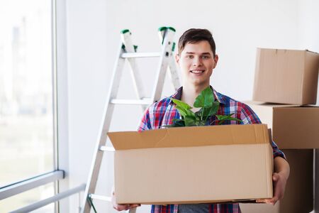 Happy young man moving to new homeの写真素材