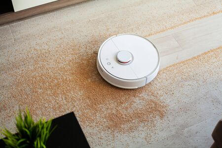 Robot vacuum cleaner performs automatic cleaning of the apartment at a certain time. Smart home.の写真素材