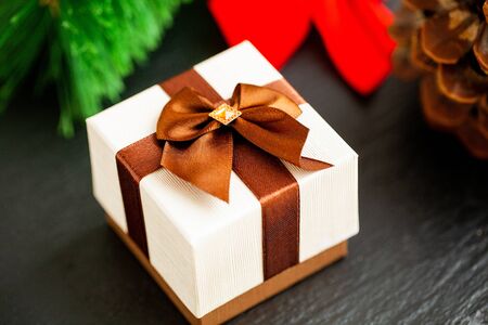 New year gift with christmas decorations on dark background