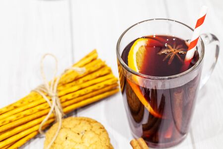 Hot mulled wine with spices on Christmas background.の写真素材
