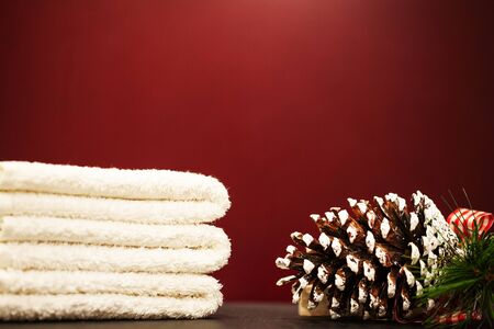 Christmas decoration and spa towels on red backgroundの写真素材