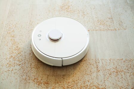Robot vacuum cleaner performs automatic cleaning of the apartment at a certain time. Smart home.の写真素材
