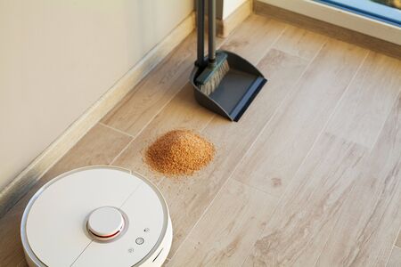 Robot vacuum cleaner performs automatic cleaning of the apartment at a certain time. Smart homeの写真素材