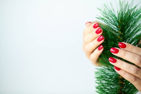Red Christmas manicure make in beauty studio on Christmas background.の写真素材