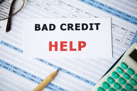 Bad credit, written on a white sheet of paperの写真素材