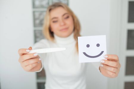 Happy woman Looking at a Pregnancy Test after result.の写真素材