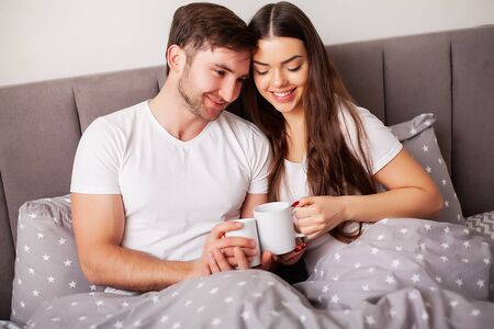 Intimate sensual young couple in bedroom enjoying each otherの写真素材
