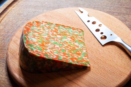 Chunk of colored cheese on wooden backgroundの写真素材