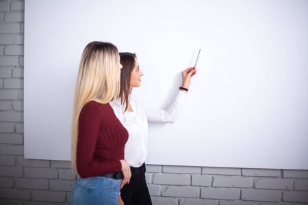 Two female colleagues in office working together.の写真素材