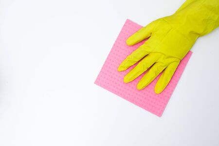 Young woman in gloves cleaning office table