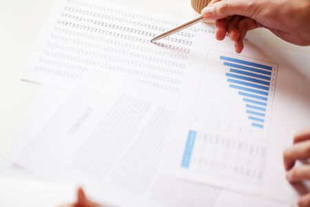 Businessman sitting at office desk signing a contract.