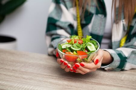 Woman holding a salad in her hands for a healthy lifestyle.の写真素材
