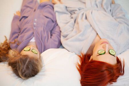 Mom and daughter doing spa treatments at home.の写真素材