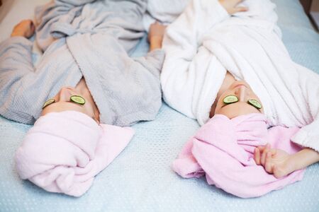 Two pretty girls doing facial spa treatments