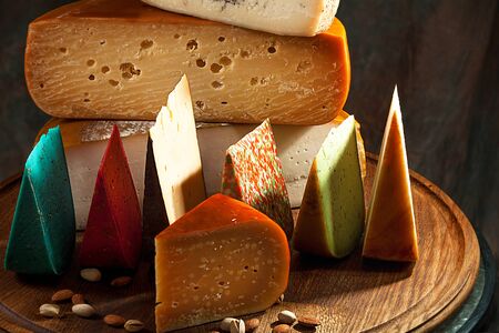 Elite variety of cheese on wooden background.
