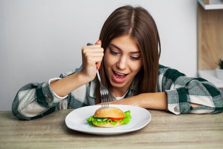 Nice girl wants to eat hamburger harmfulの写真素材
