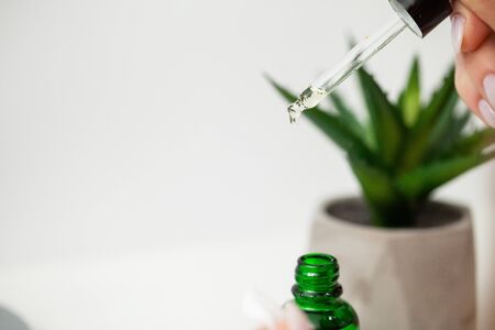 Close up girl puts lotion for face care on handの写真素材