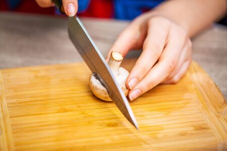 Concept of healthy eating, woman cuts fresh vegetables for salad