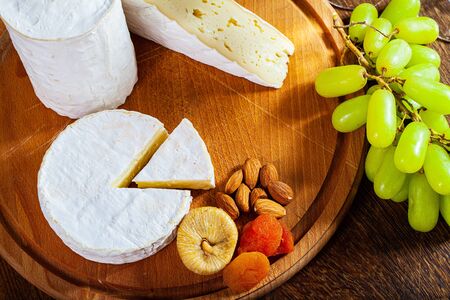 Camembert cheese or brie on wood background.の写真素材