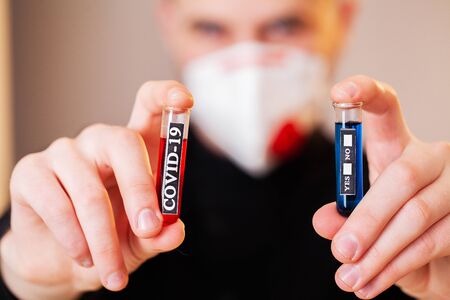 Doctor holds test tube with covid-19 test