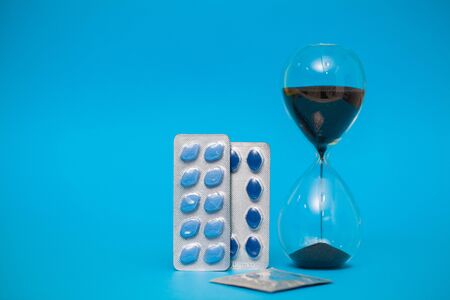 Pills for sexual male health on a blue background