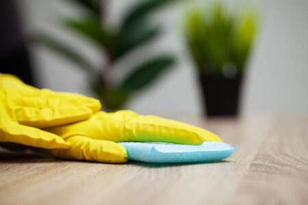 Closeup of a cleaning company worker cleans officeの写真素材