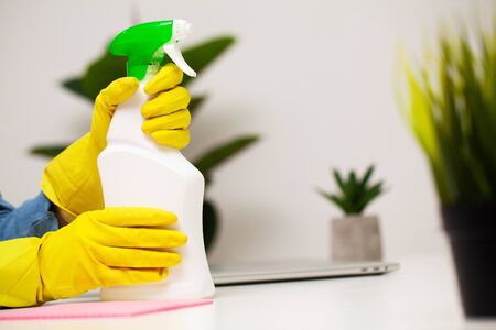 Closeup of a cleaning company worker cleans officeの写真素材