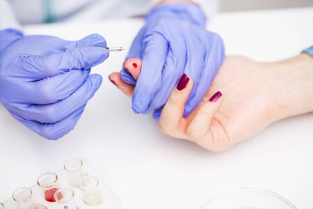 Woman at the hospital submits a blood test for a coronavirus