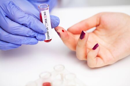 Woman at the hospital submits a blood test for a coronavirus
