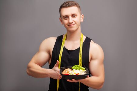 Trainer consumes a high-protein meal of meat and fruitの写真素材