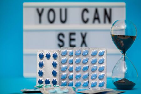 Pills that promote sexual health for men for a long time on blue backgroundの写真素材