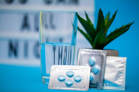 Pills that promote sexual health for men for a long time on blue background