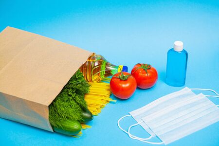 Donation package with food and personal protective equipment for people in needの写真素材