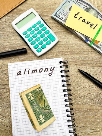 One parent splits money for himself and for the payment of alimony for his child.の写真素材