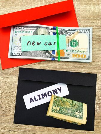 Concept of paying alimony, stack of money on the table.の写真素材