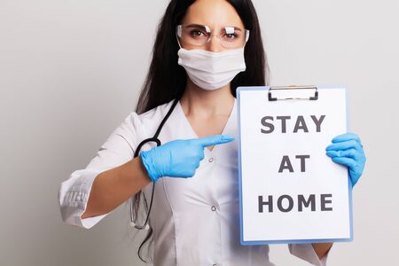 Medicine concept, doctor with a paper with stay at home holding on handの写真素材