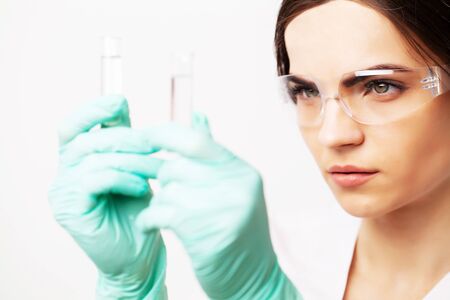 Female doctor in laboratory holding holding test tubes with experimental antiviral vaccineの写真素材